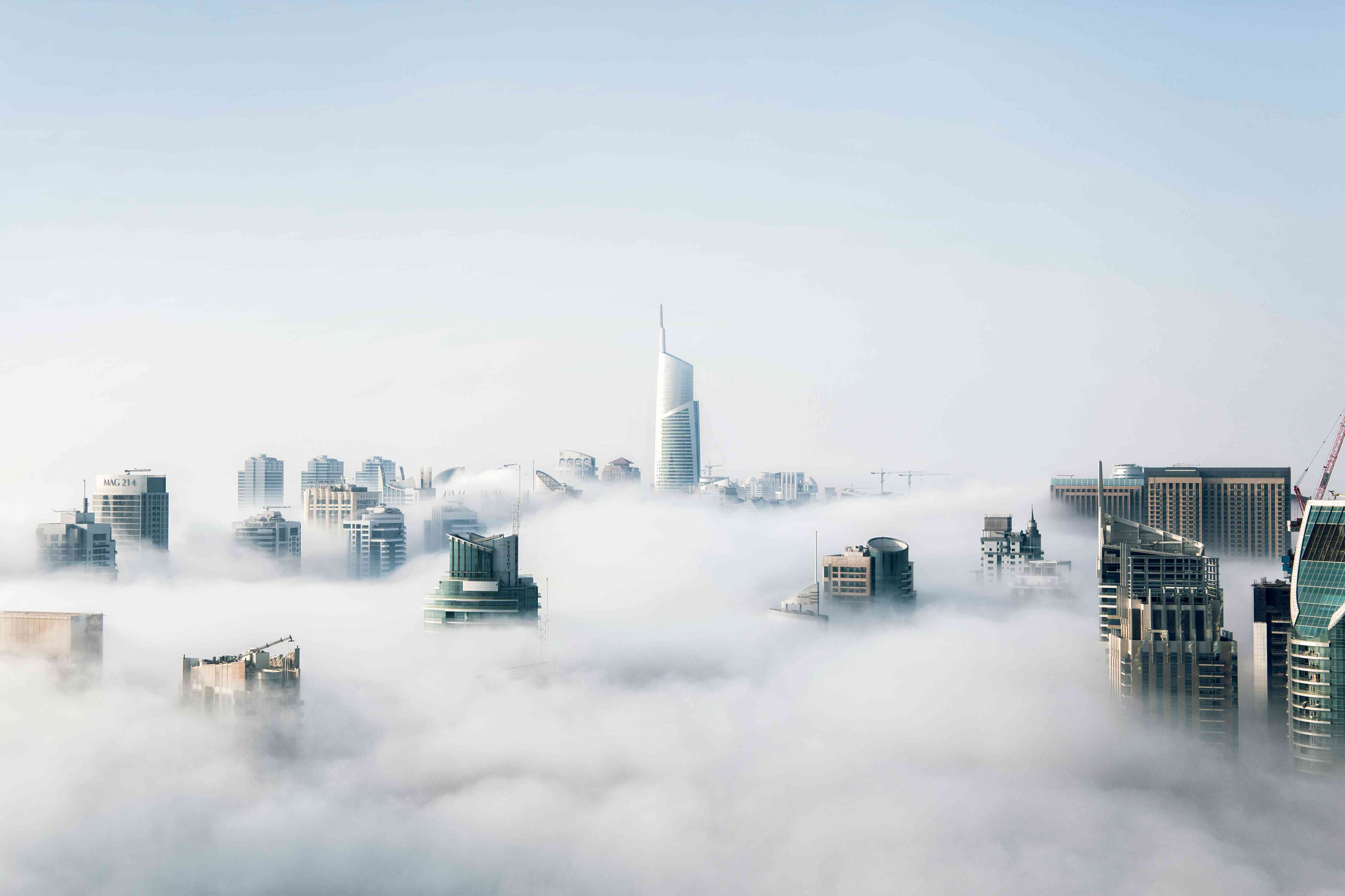 Dubai Skyline Wallpaper 4K - Foggy City Above Clouds | MirrorLog